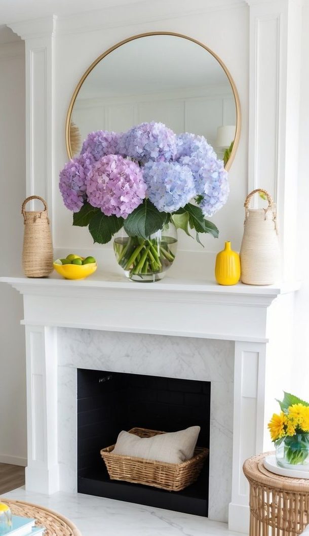 A vase of vibrant hydrangea blooms sits atop a white mantel, surrounded by natural elements and bright summer decor